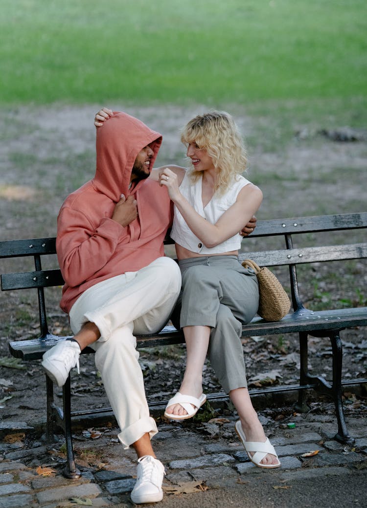 Woman And Man Smiling On Bench