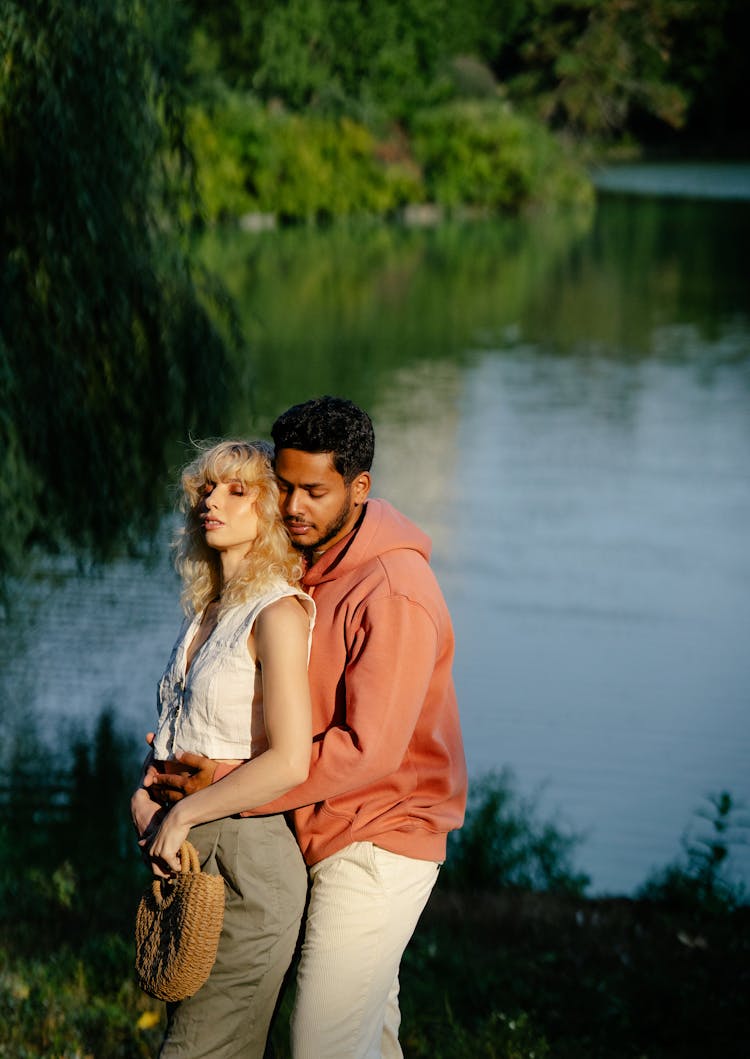 Man Hugging Woman Near River