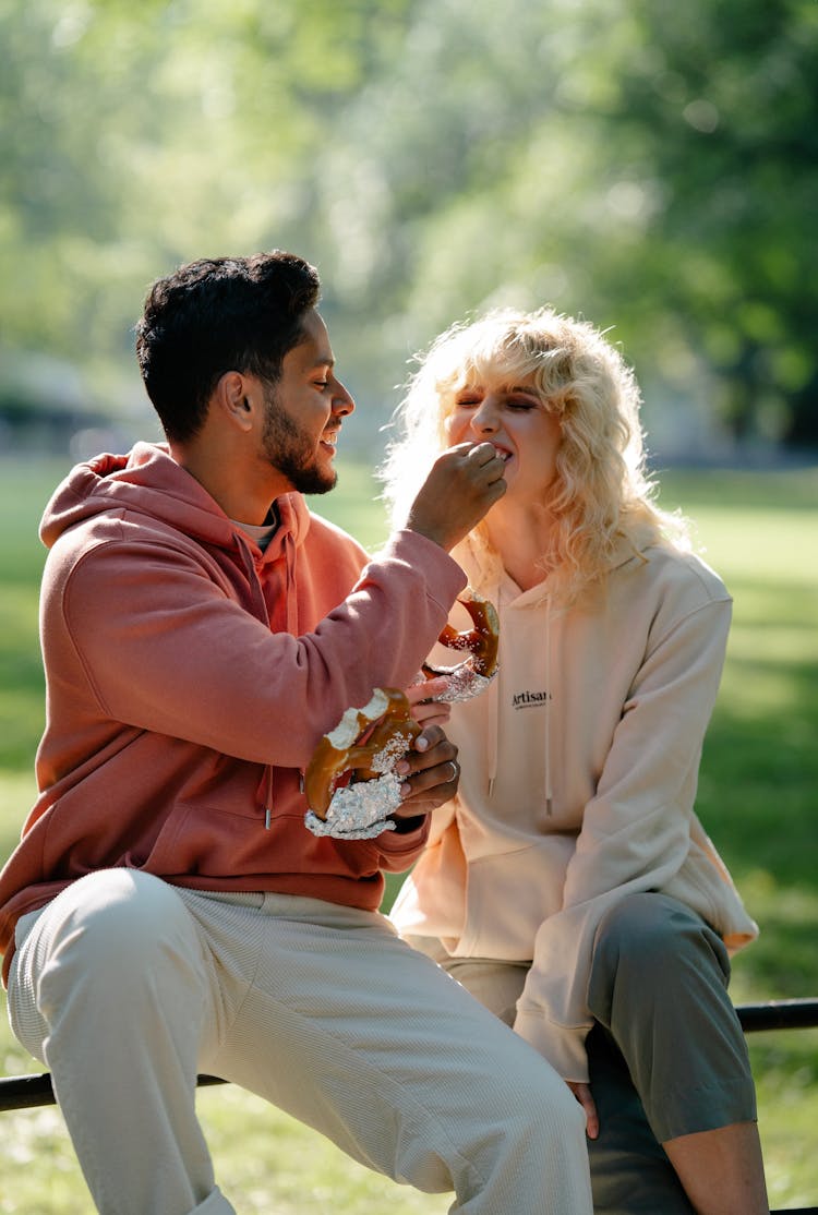 Man Giving Pretzel To Woman 