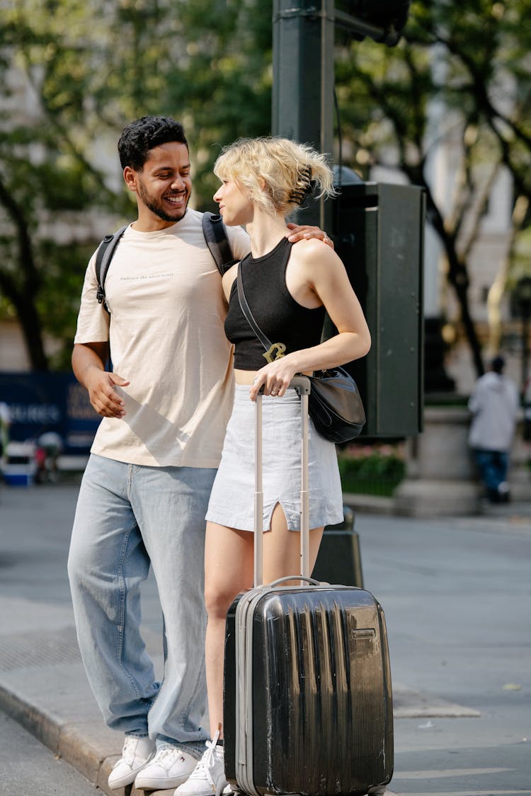 Couple With A Suitcase On A City Street