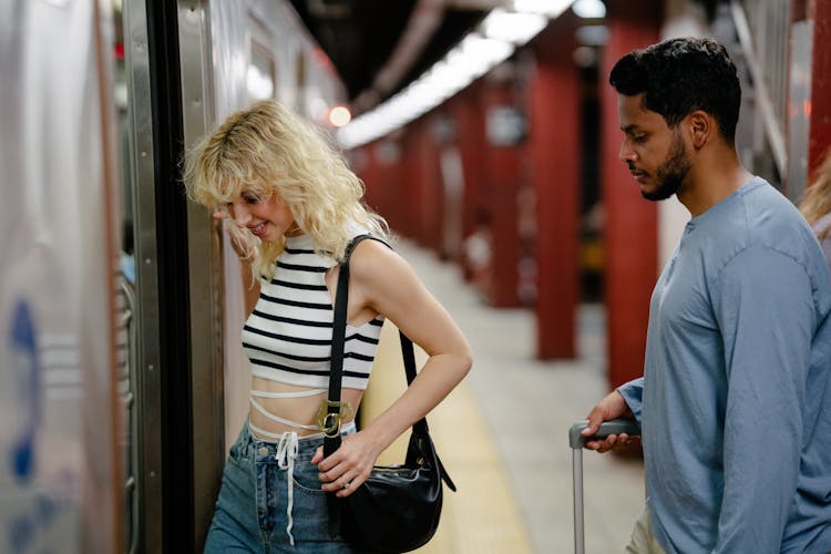 Couple Boarding A Subway Train