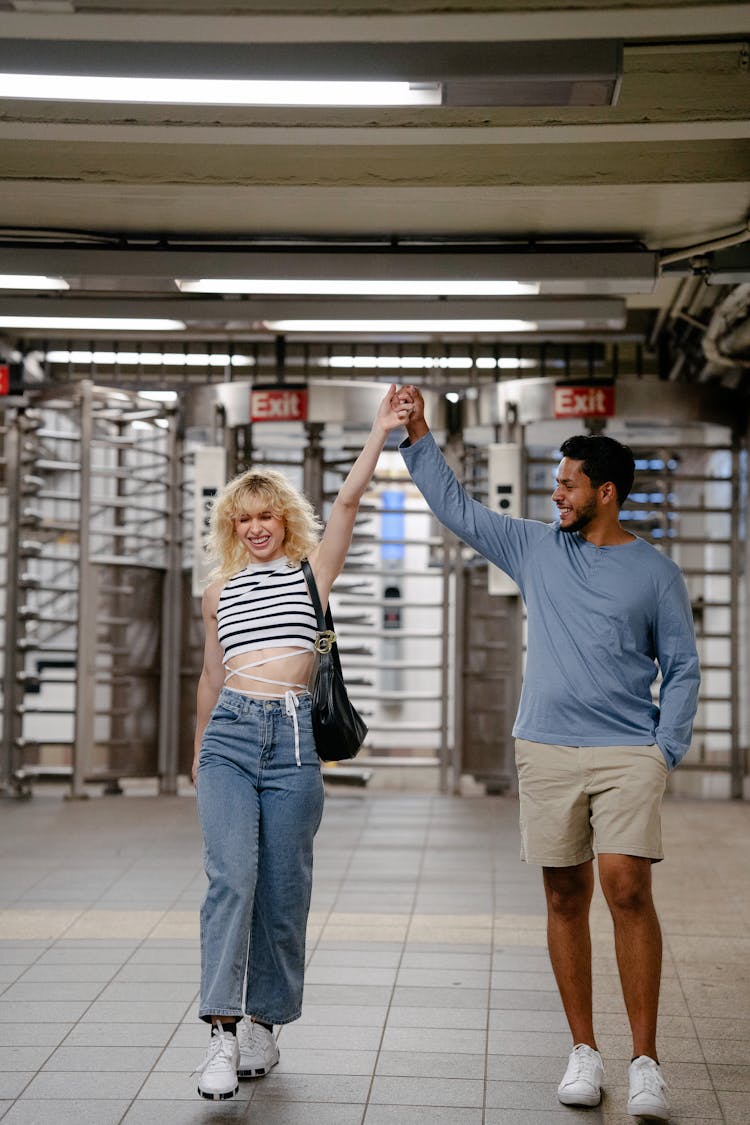 Couple At Underground Station Exit Rising Arms