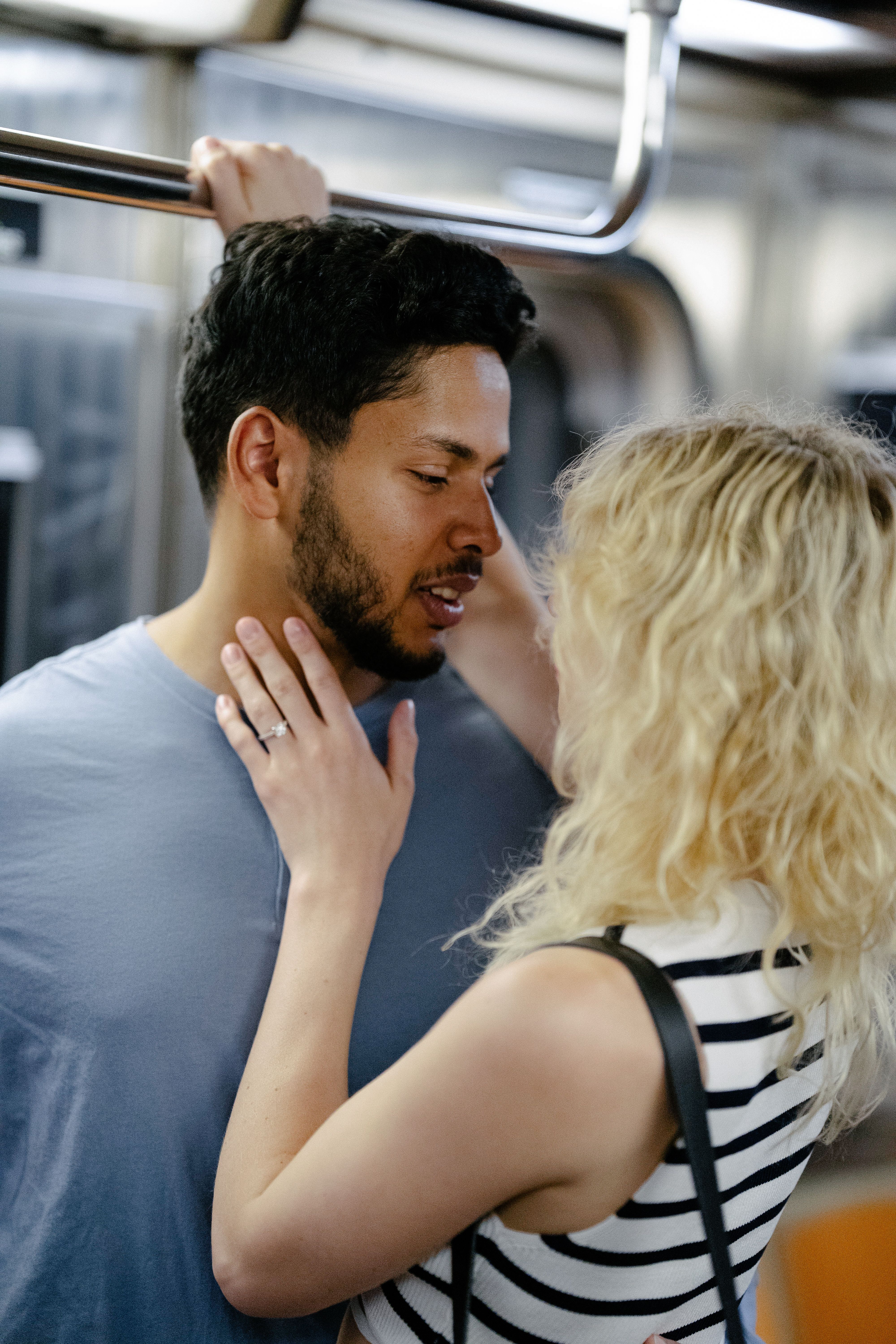 A couple sharing an intimate moment on a train, illustrating romance and travel.