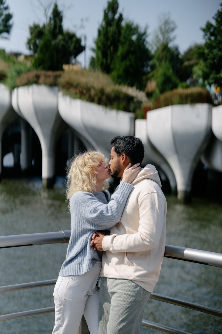 A Couple Kissing By A Lake