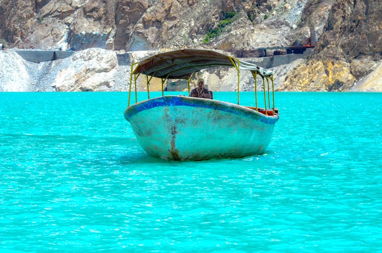 Man Cruising A Boat At Sea