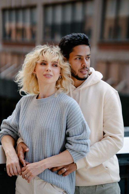 Free A young couple embraces warmly in an urban outdoor setting, exuding modern style and affection. Stock Photo