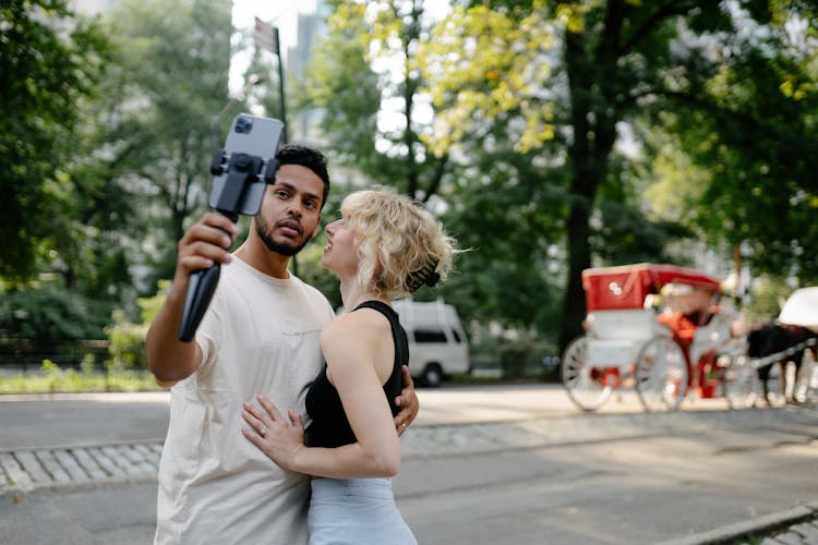 A Couple Taking A Selfie With A Smart Phone