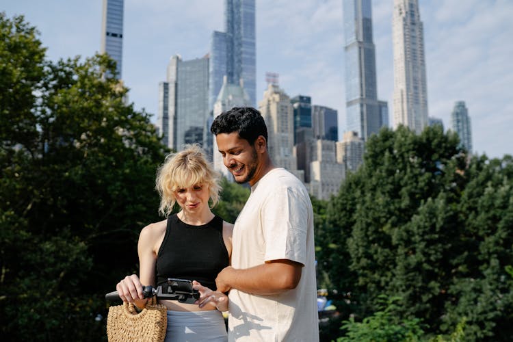 A Couple Looking At A Smart Phone