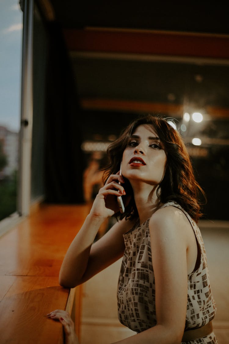 Woman In Sleeveless Dress Talking On The Phone