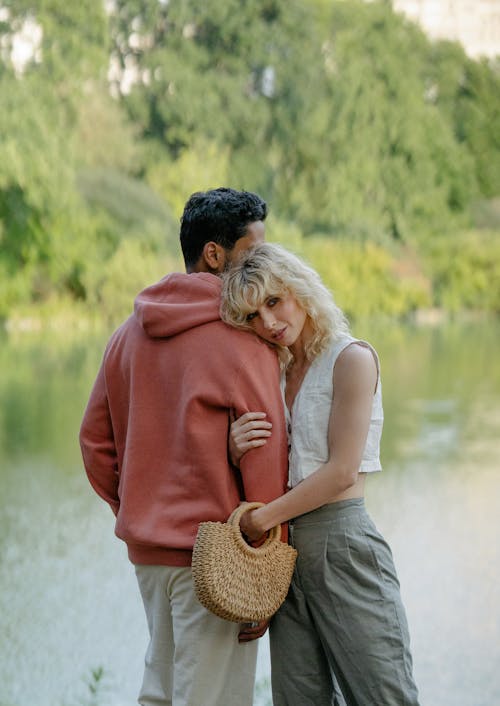 Woman Hugging Man near River