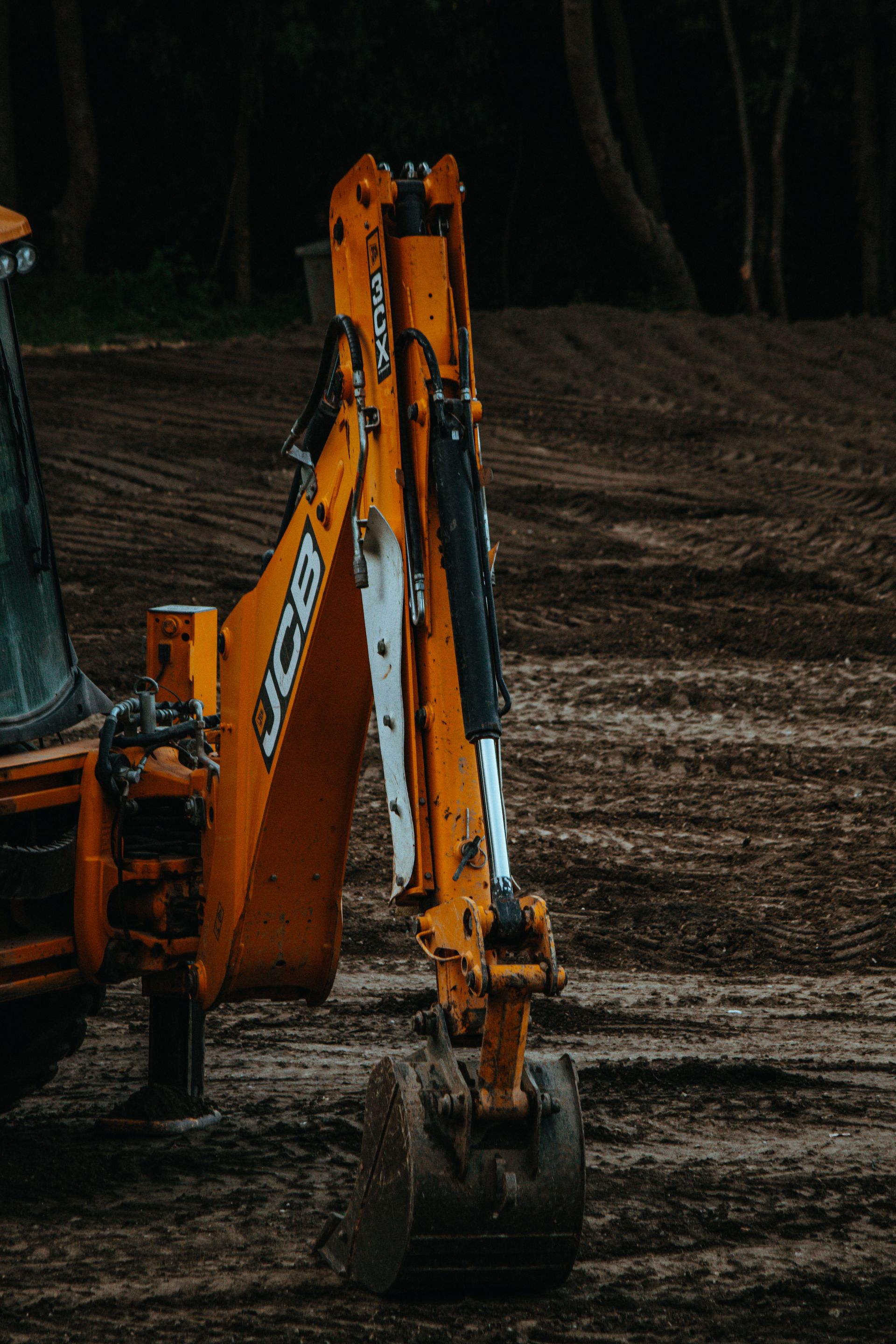 Excavator mid-dig on a deep foundation cut