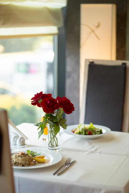 Close-up Photo of Three Red Roses in Clear Vase Centerpiece