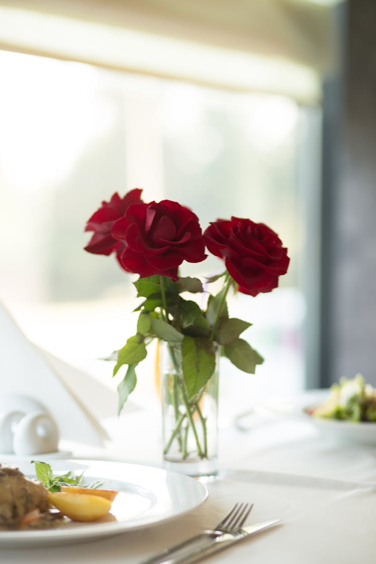 Red Roses On Glass Vase