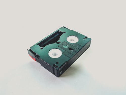 Black Cassette Tape on White Wooden Table