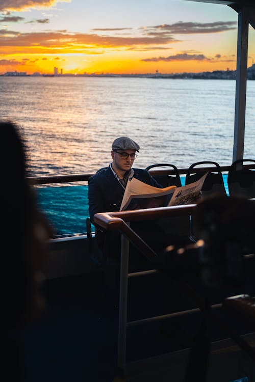 Man on a Ferry Boat Reading Newspaper