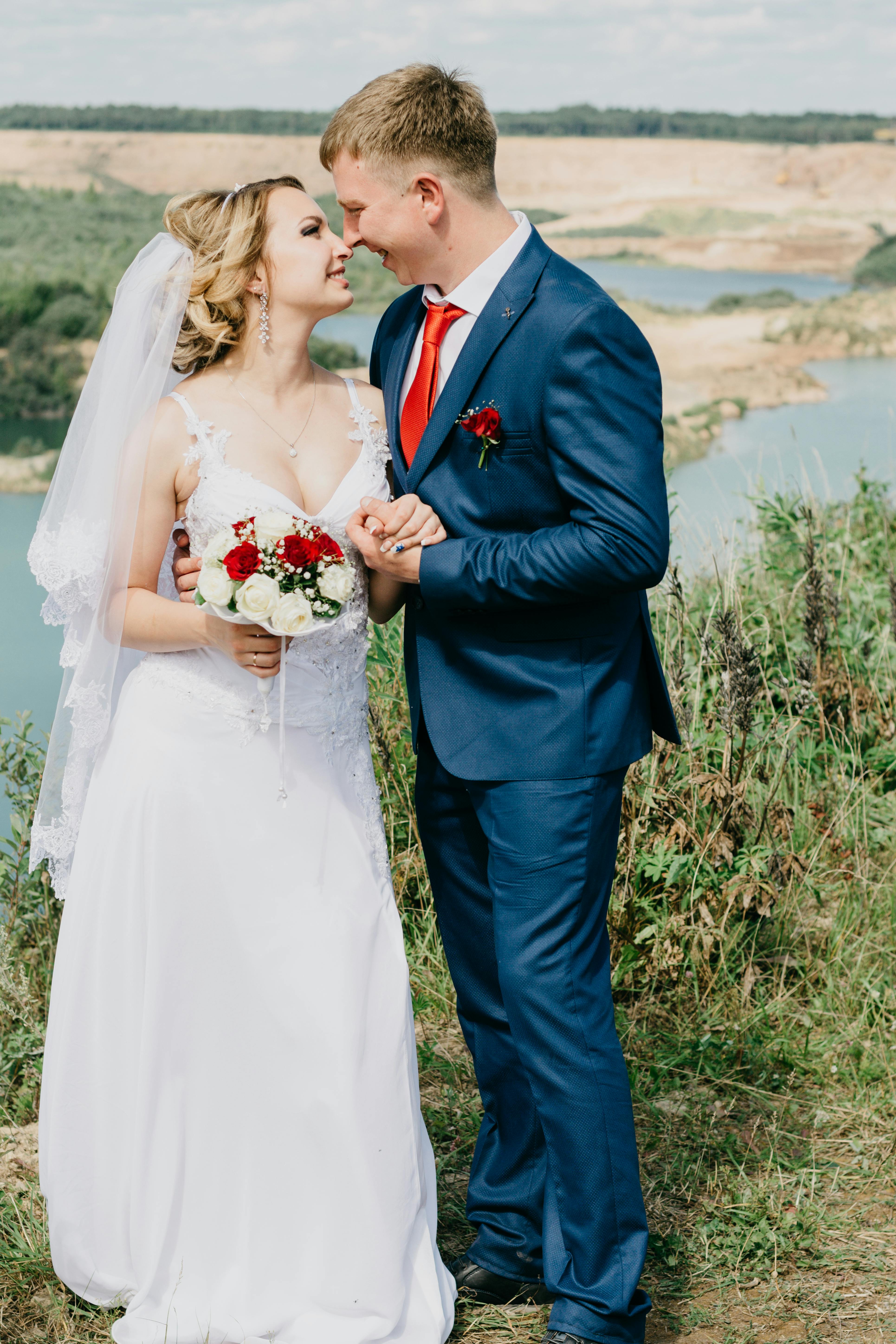 woman holding flower bouquet looking at man near green plants