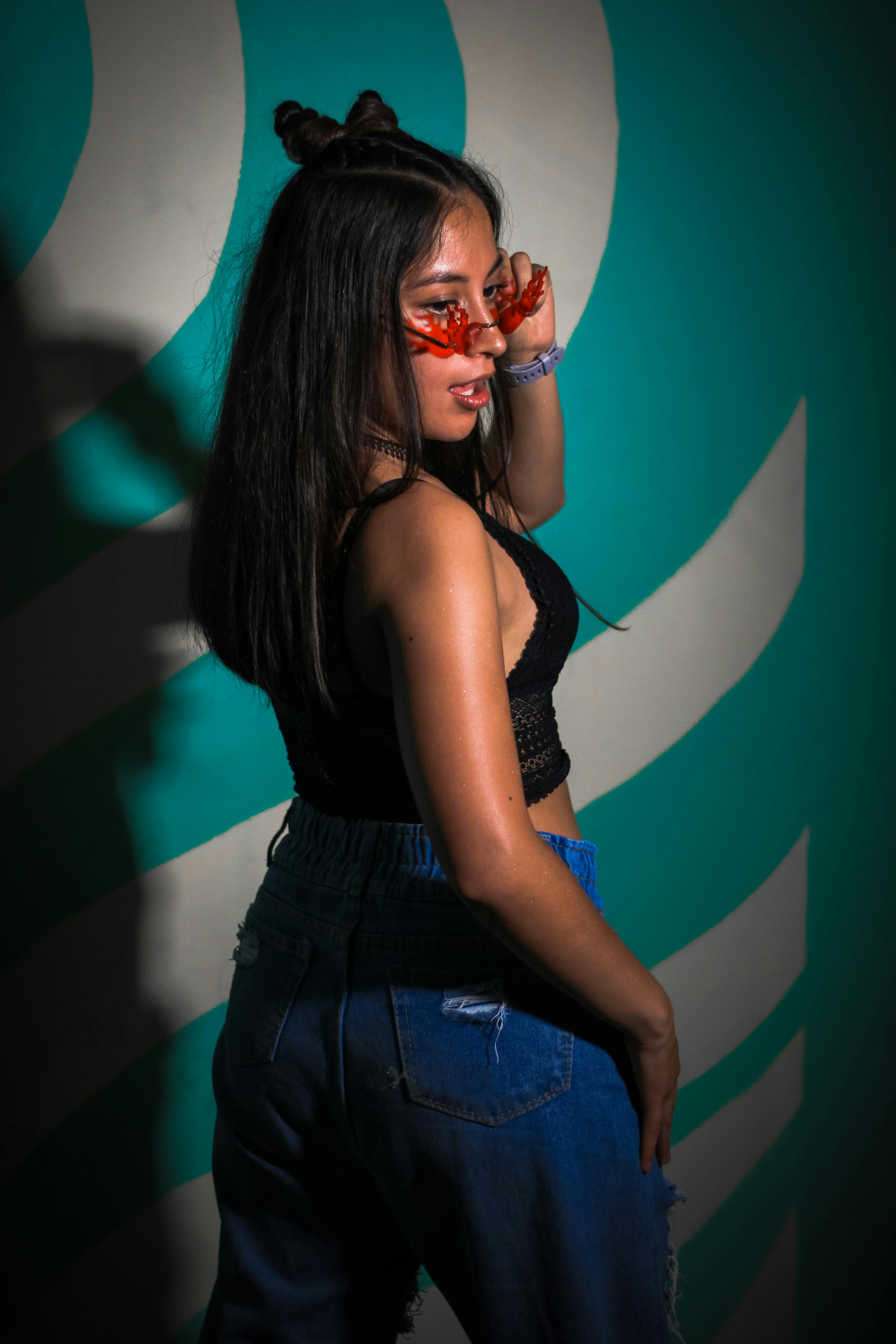 A woman in a crop top and jeans poses for a picture photo – Free Mexico  Image on Unsplash