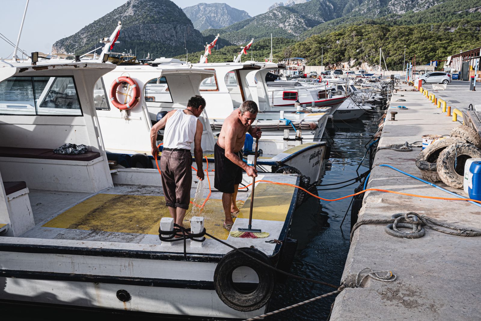 Buffing compound being worked into a faded boat hull