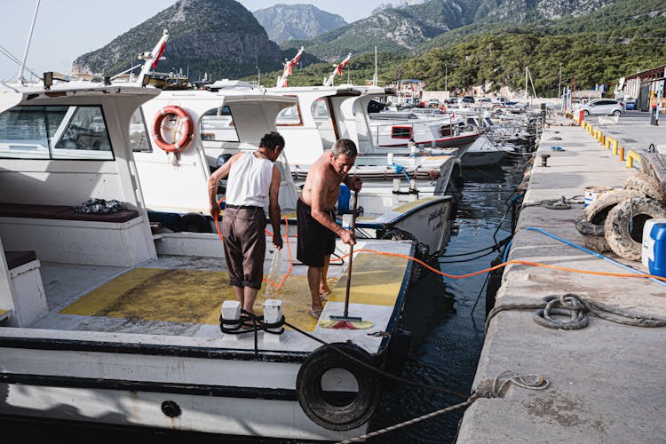 Men Cleaning The Boat Deck