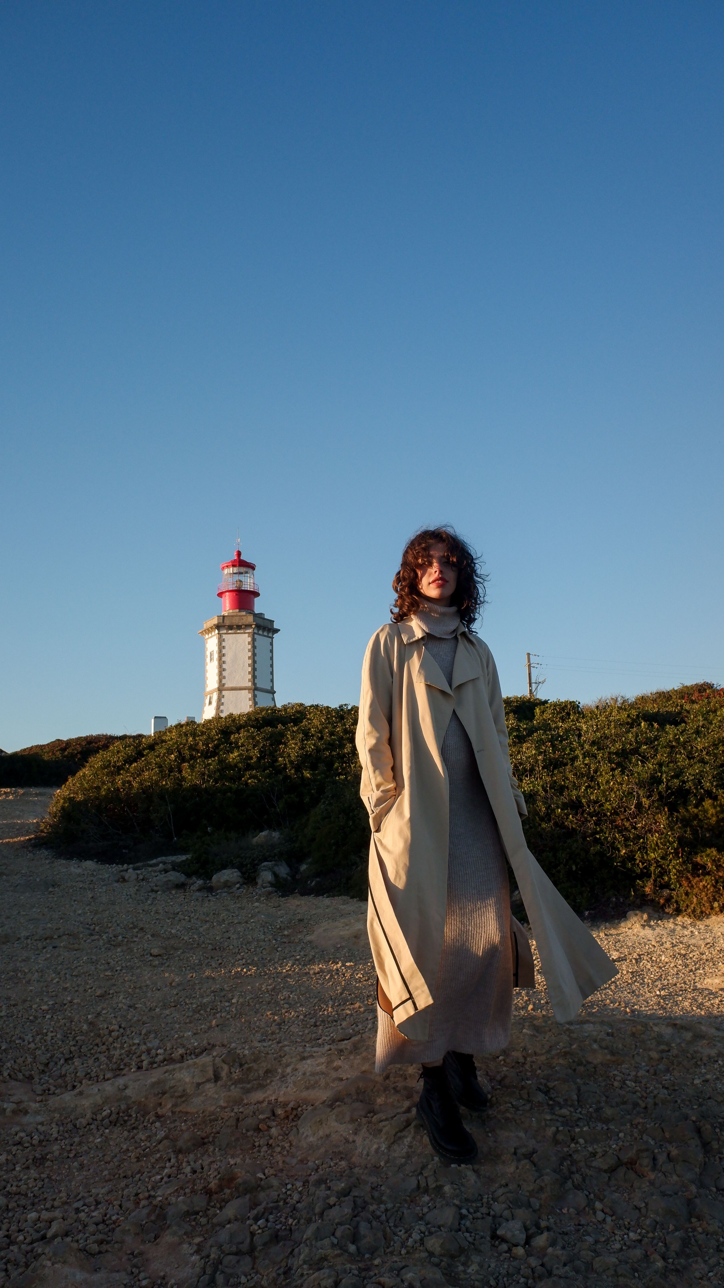 Woman in Beige Coat Standing Near the Lighthouse · Free Stock Photo