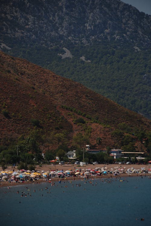 Mountains and Beach Full of Tourists 