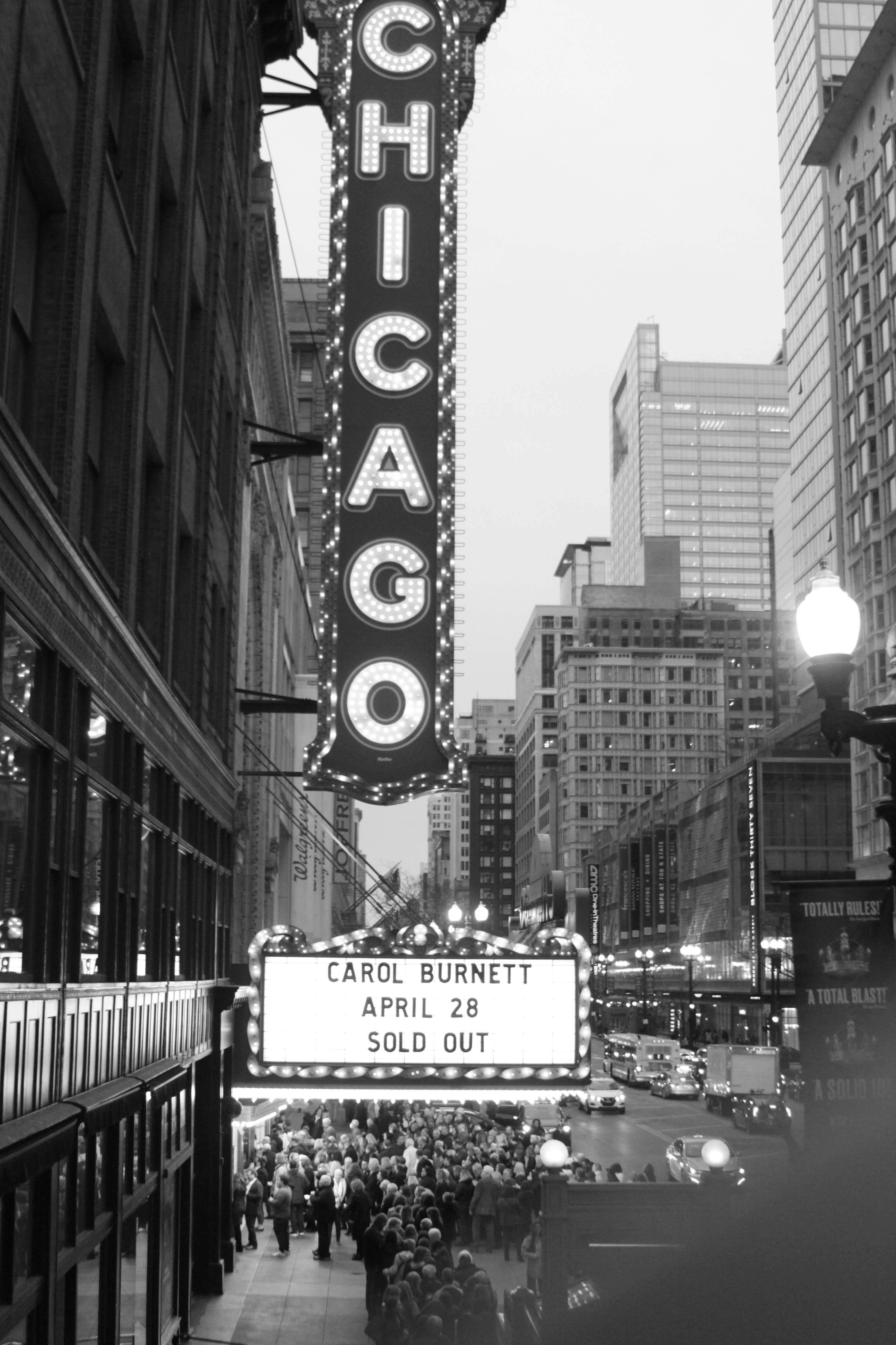 Free Black-and-white photo of Chicago theater with marquee and city street scene. Stock Photo