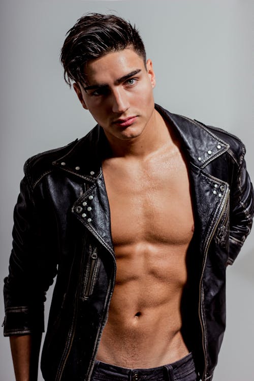 A Man in Black Leather Jacket Posing at the Camera