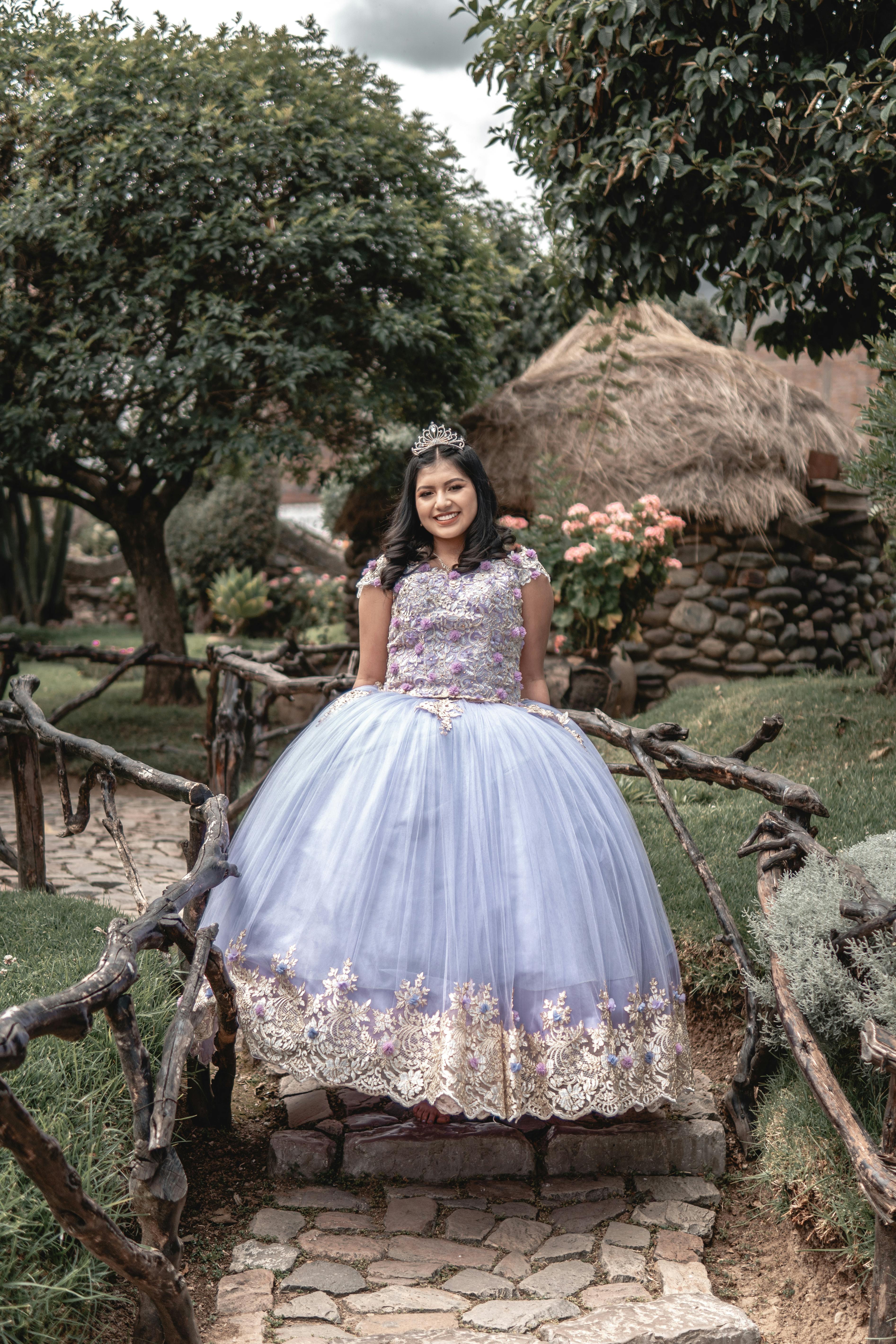Young woman in an elegant ball gown enjoying a pleasant day in Huancayo, Peru's picturesque park.