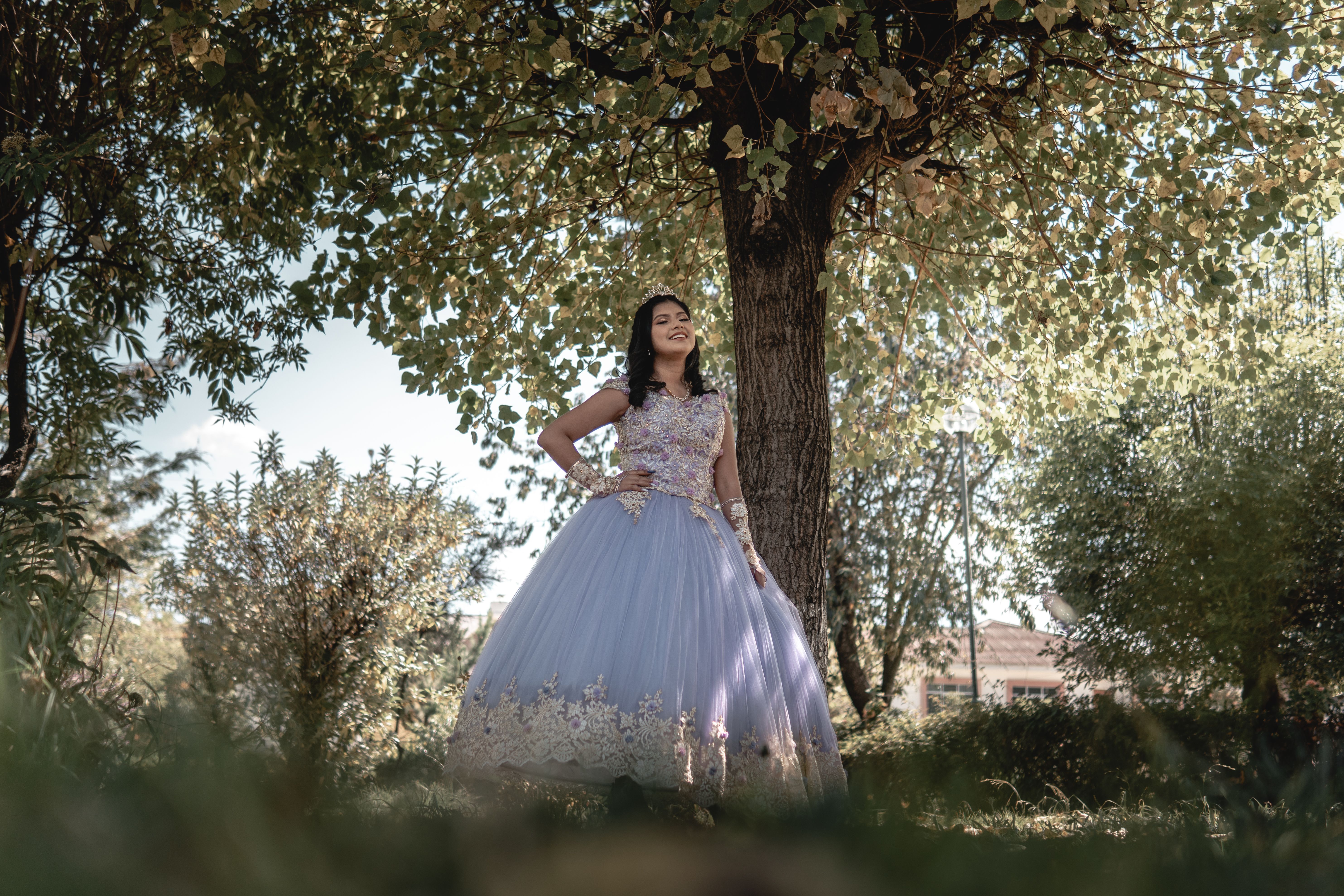 A Beautiful Young Woman Standing Near Green Tree while Posing at the ...