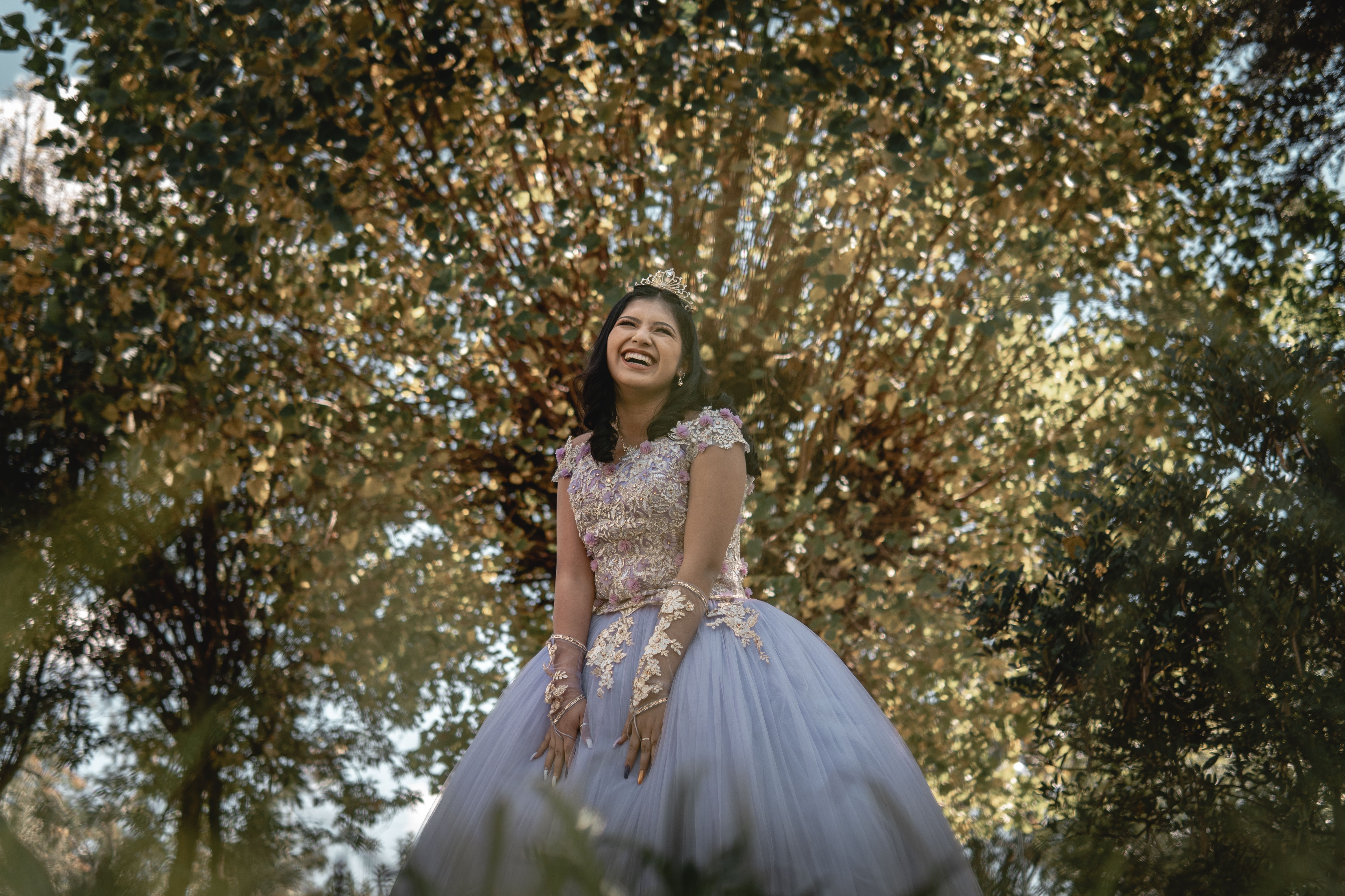 A Beautiful Young Woman Standing Near Green Tree while Posing at the ...