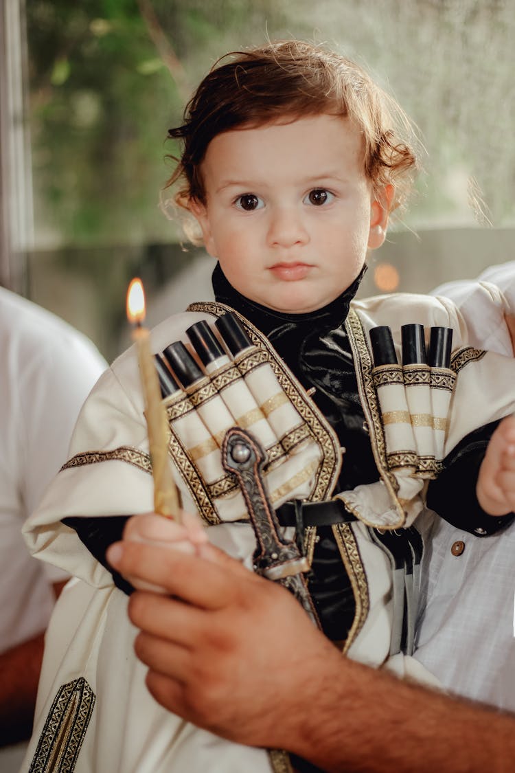 Man Holding Wax Candle And Boy