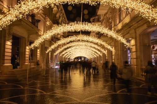 Free Stunning display of arches with sparkling lights on a busy street in Baku, captured at night. Stock Photo