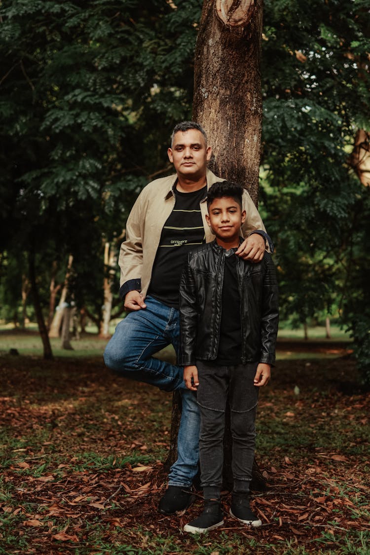 Father And Son Posing In Park