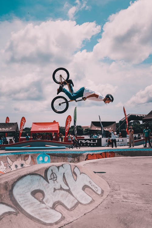 Man Riding on Bicycle Over the Ramp