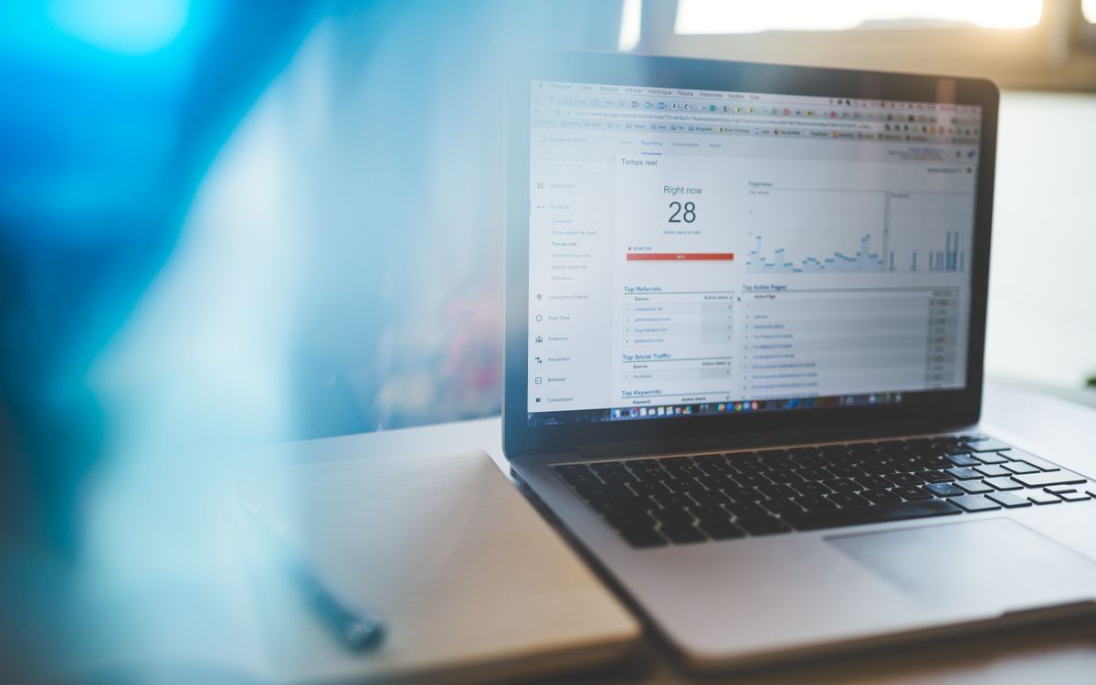 Laptop displaying Google Analytics in a modern workspace, highlighting digital analytics and technology.
