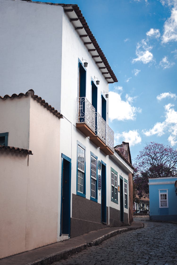 White And Blue Concrete Building With Balconies 