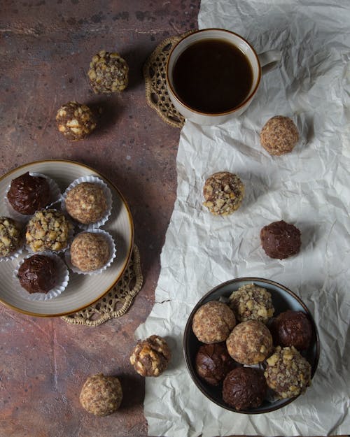 Free Pralines and Coffee Cup on Table Stock Photo