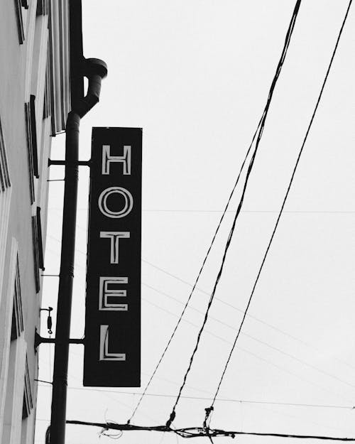 Grayscale Photo of a Hotel Signage