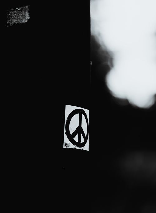Free Artistic black and white photo featuring a peace symbol on a dark background. Stock Photo