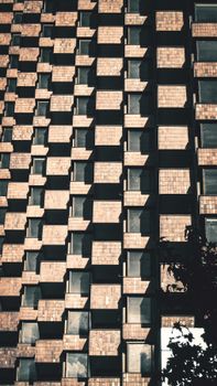Low-angle view of a modern building's facade, showcasing unique geometric patterns in Bogotá, Colombia.