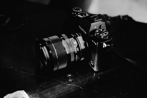 Free Fujifilm camera with lens in black and white, showcasing elegance and technology. Stock Photo