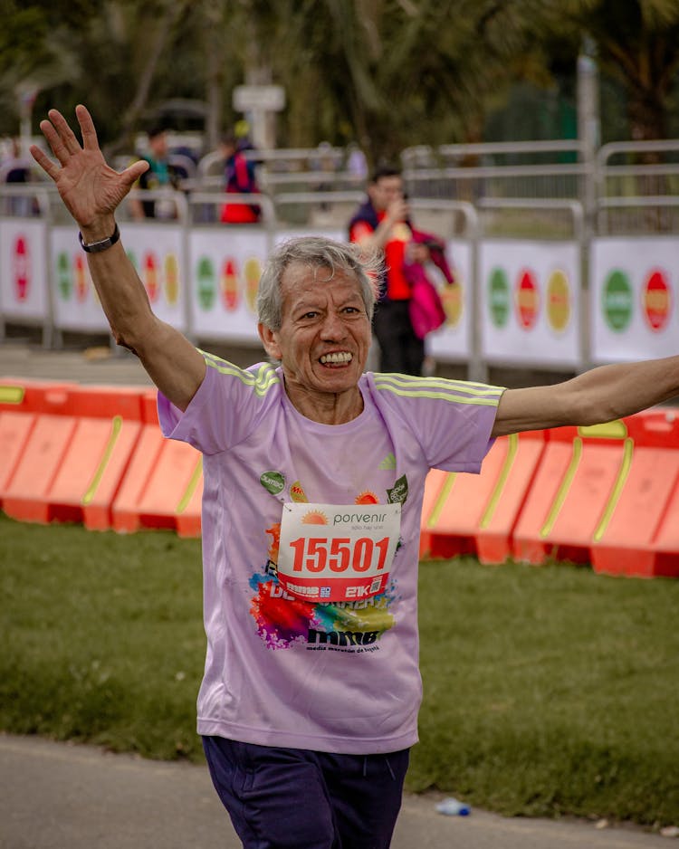 Gray Haired Man Running On A Marathon 