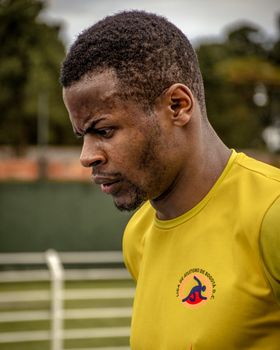 Close-up of a determined male athlete training outdoors in Bogotá, Colombia.