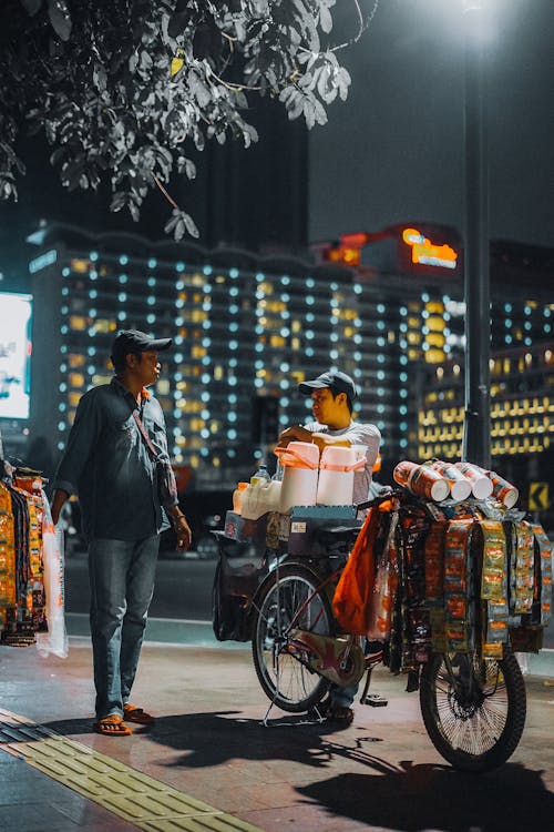 Man Selling on the Bicycle in the Sidewalk