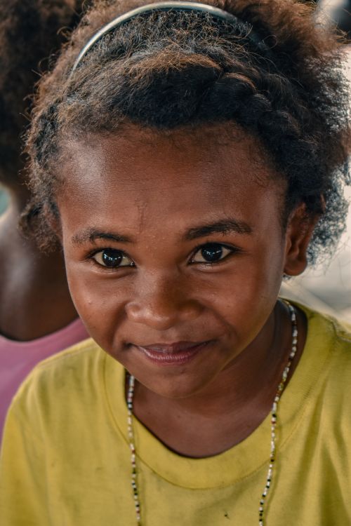 Free Candid close-up of a smiling child wearing a yellow shirt in Floridablanca, Philippines. Stock Photo