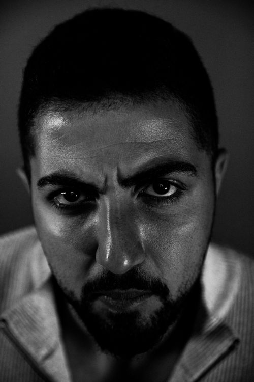 Free Intense monochrome headshot capturing a serious expression in low light. Stock Photo