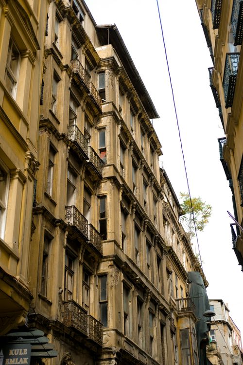 Free Low-angle view of historic European buildings with ornate facades and wrought iron balconies. Stock Photo