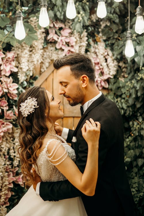 Woman and Man Hugging in Wedding Dress and Suit