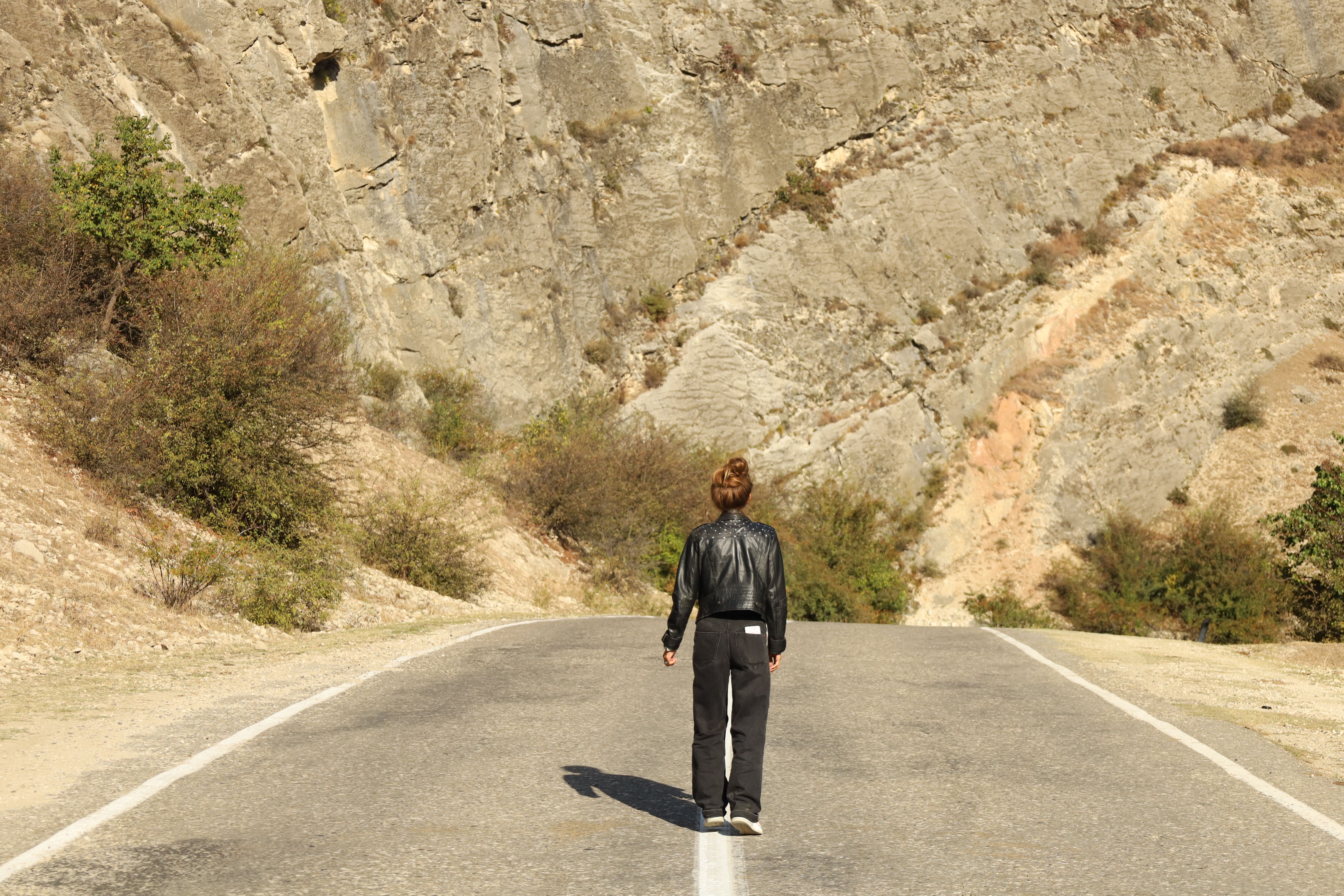 Woman in Black Jacket Standing on Road · Free Stock Photo