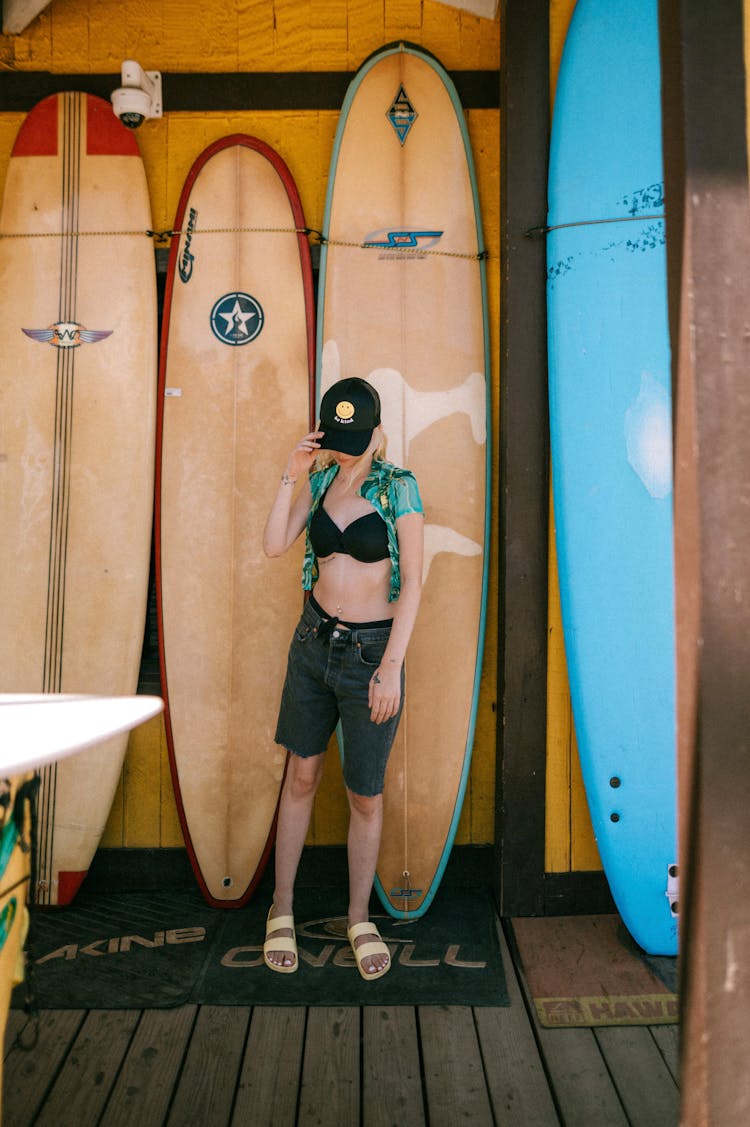 Woman And Surfboards Behind